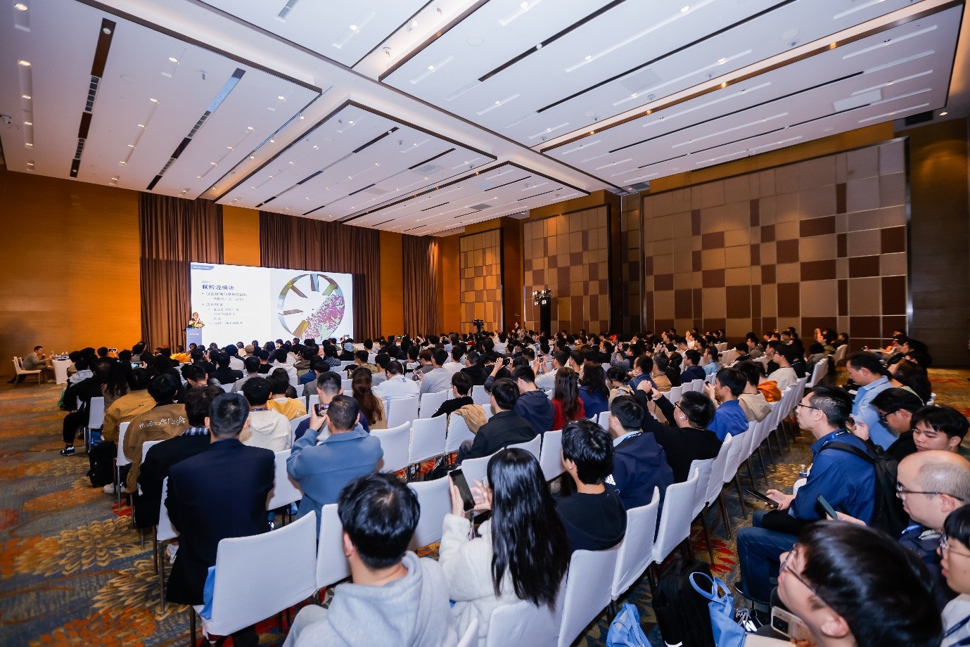 An advertisement for the COMSOL Conference 2025 Boston showing one presenter on stage.